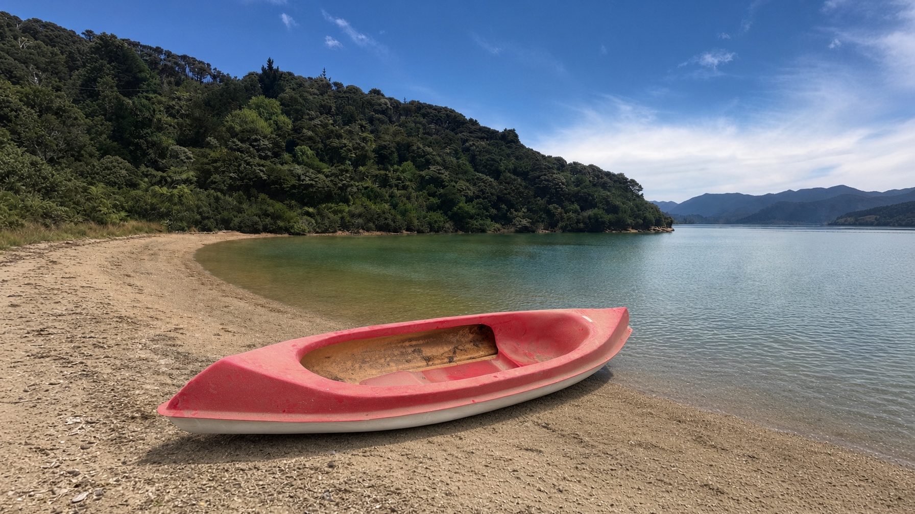 Free kayak sitting on Sandy Bay beach